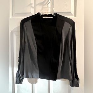 Cropped jacket with zipper. Buckle sleeve accent.